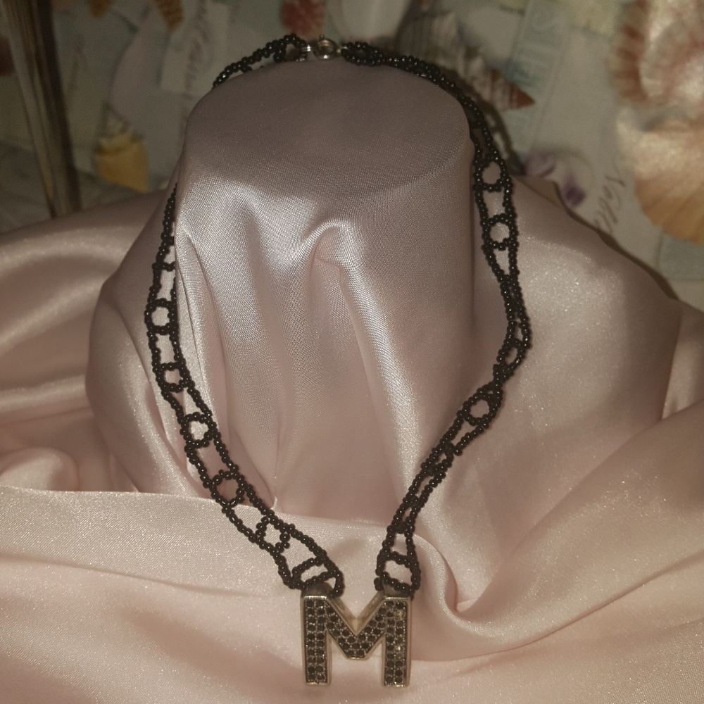 "M" hmmmm  interesting necklace.
